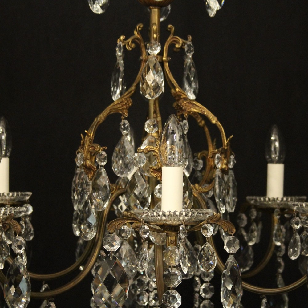 An antique French six-arm crystal chandelier featuring a gilt metal cage frame suspended with faceted glass drops and glass drip pans. View VI