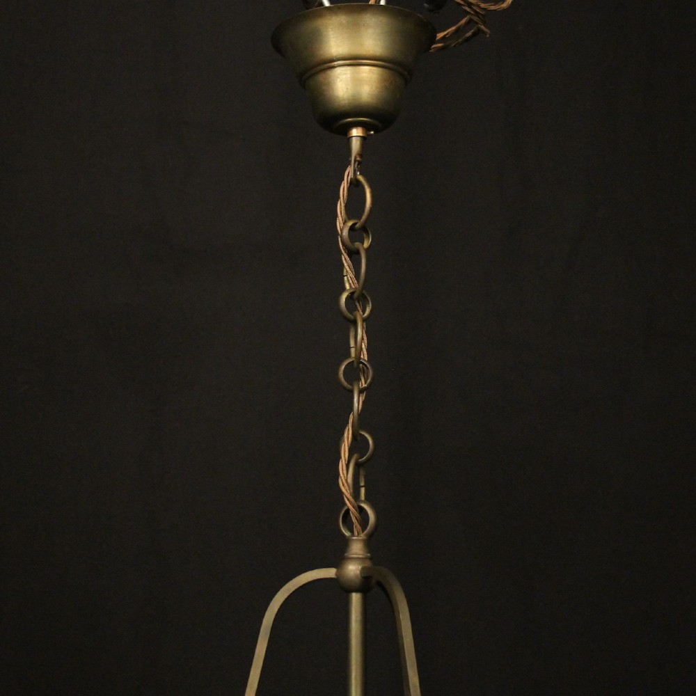 A cylindrical gilt brass hall lantern featuring curved clear glass panels, a central three-light candle fixture, and a suspended hanging chain. View IX