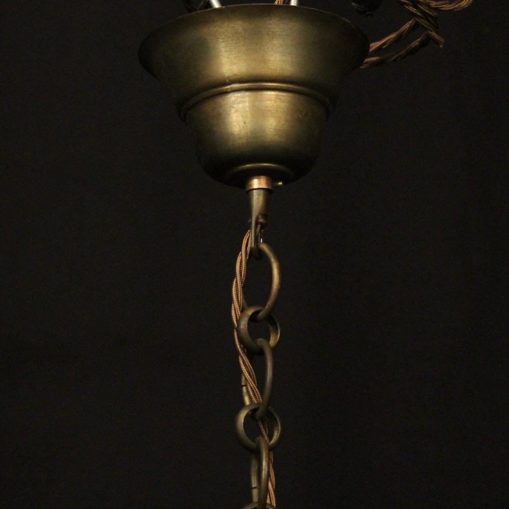 A cylindrical gilt brass hall lantern featuring curved clear glass panels, a central three-light candle fixture, and a suspended hanging chain. View X