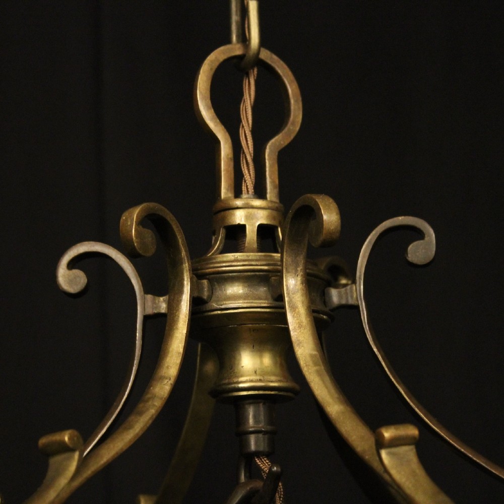 A pair of antique brass hexagonal hall lanterns with glazed glass panels and triple candle-style light fittings suspended from chains. View VIII