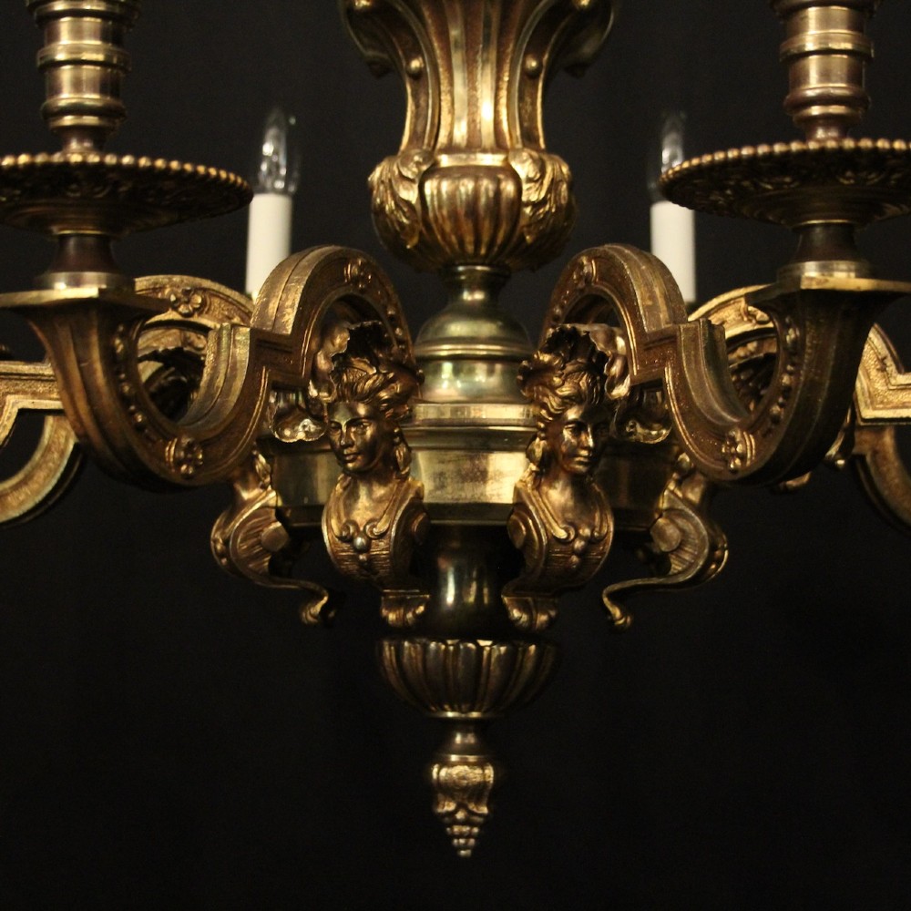 An antique French eight-light chandelier crafted from gilded bronze, featuring sculpted figures, classical motifs, and candle-style bulb holders. View V