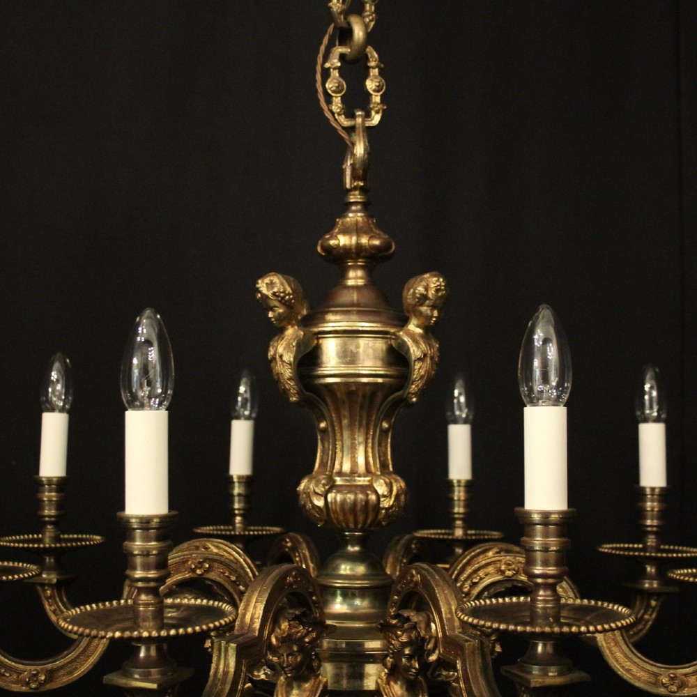 An antique French eight-light chandelier crafted from gilded bronze, featuring sculpted figures, classical motifs, and candle-style bulb holders. View VIII