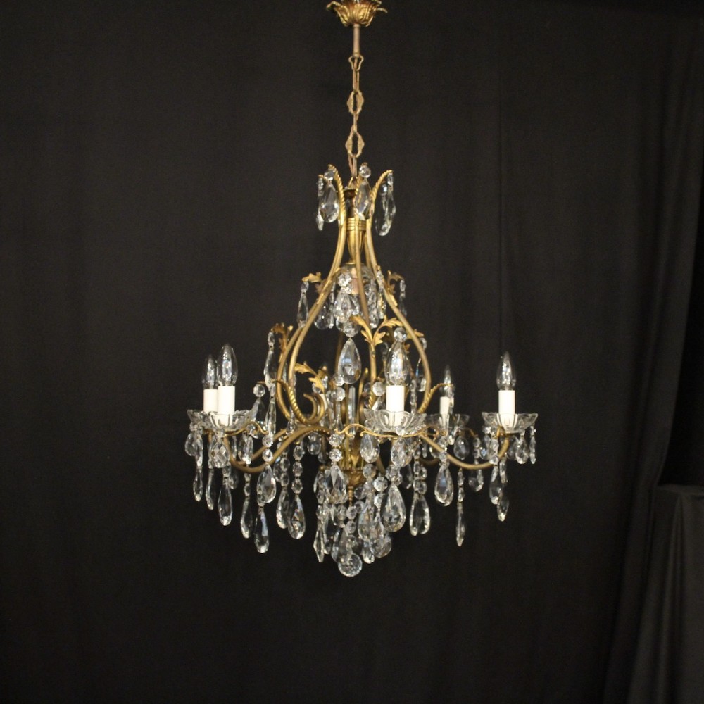 A French gilded metal cage chandelier featuring seven light points decorated with faceted crystal glass drops and candle-style bulb holders. View II