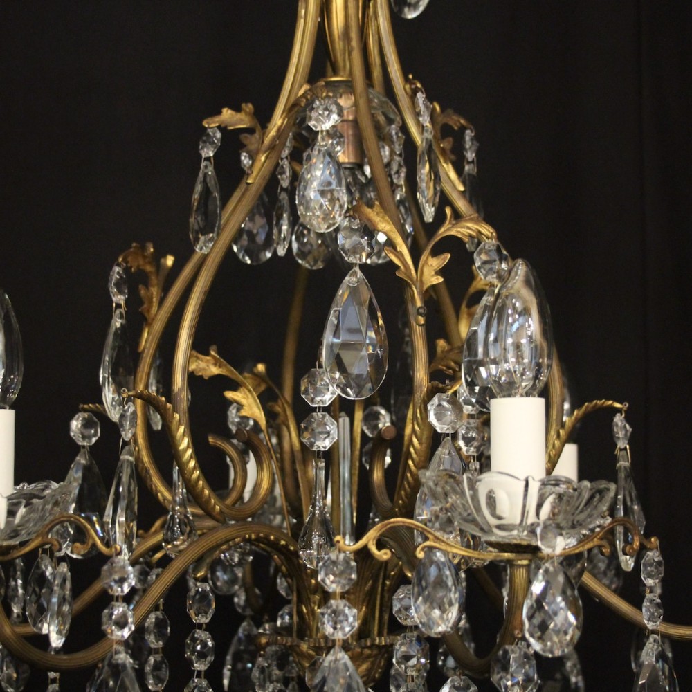 A French gilded metal cage chandelier featuring seven light points decorated with faceted crystal glass drops and candle-style bulb holders. View VIII