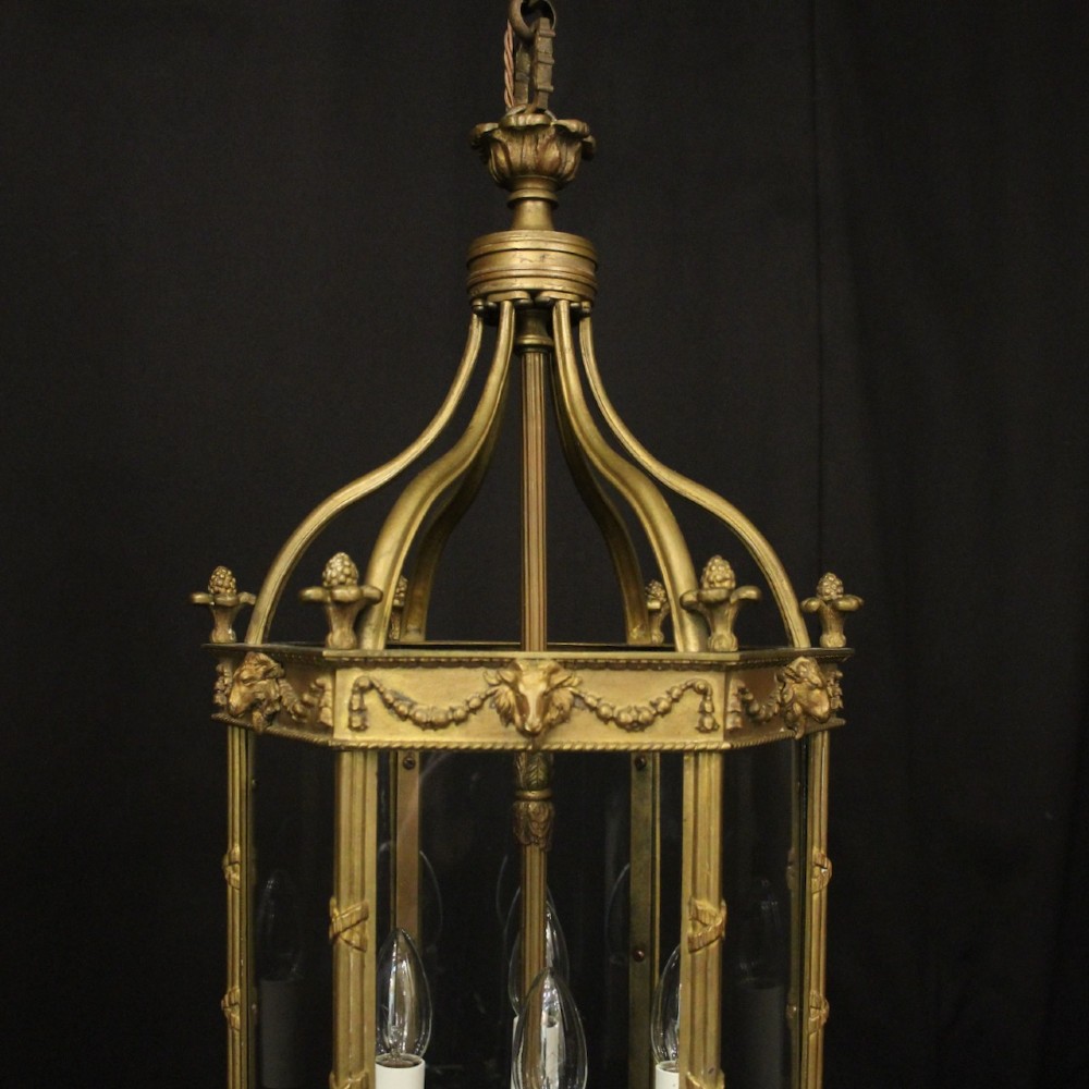 An English nineteenth-century gilded bronze four-light hall lantern with glazed glass panels and classical festoon ornamentation. View II