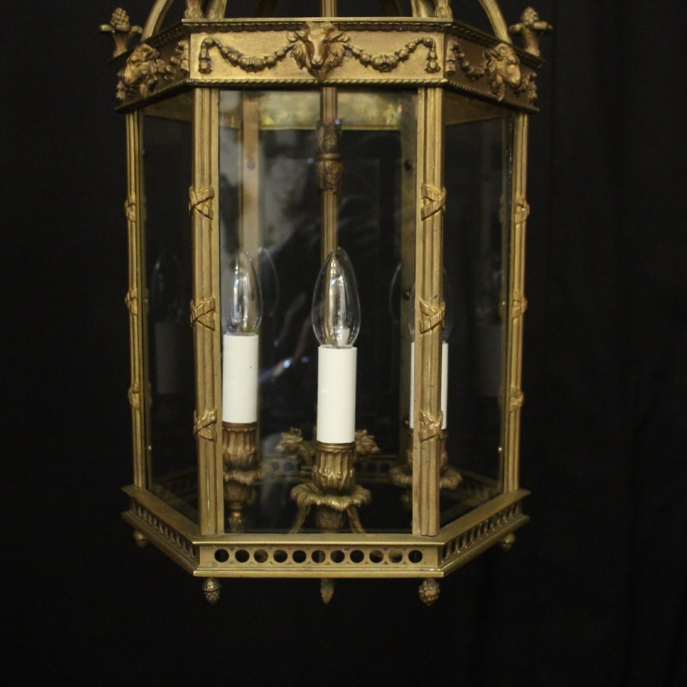 An English nineteenth-century gilded bronze four-light hall lantern with glazed glass panels and classical festoon ornamentation. View III