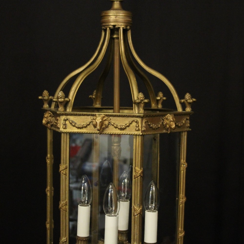 An English nineteenth-century gilded bronze four-light hall lantern with glazed glass panels and classical festoon ornamentation. View IV