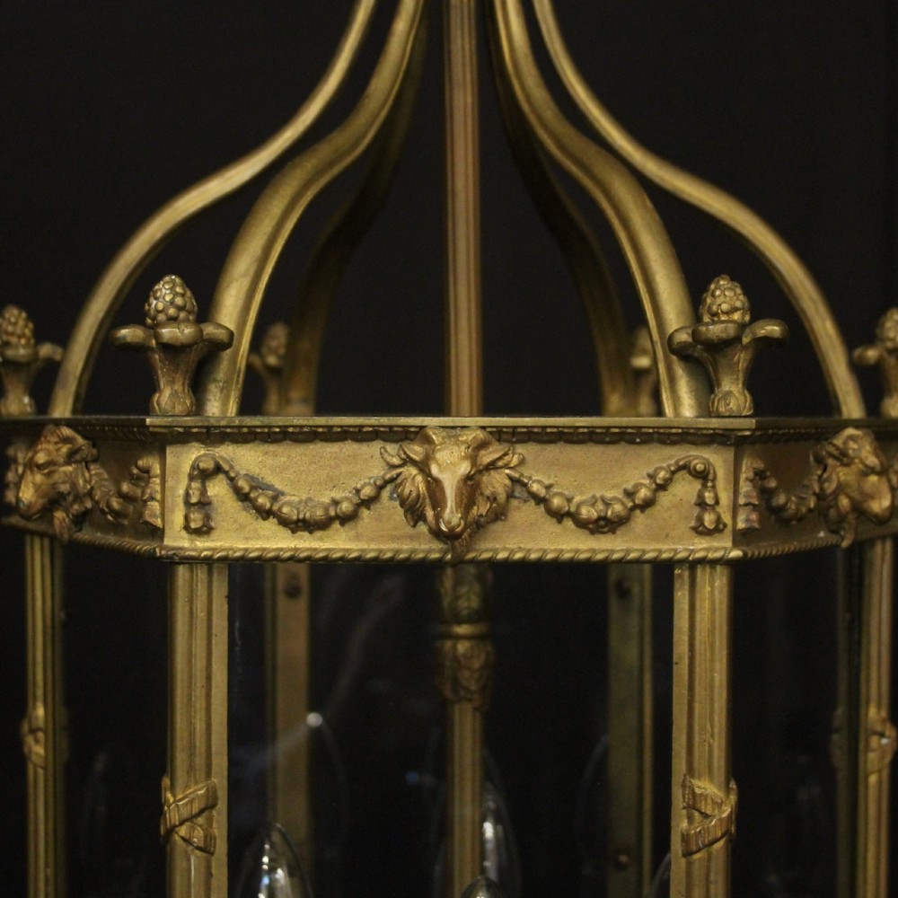 An English nineteenth-century gilded bronze four-light hall lantern with glazed glass panels and classical festoon ornamentation. View V