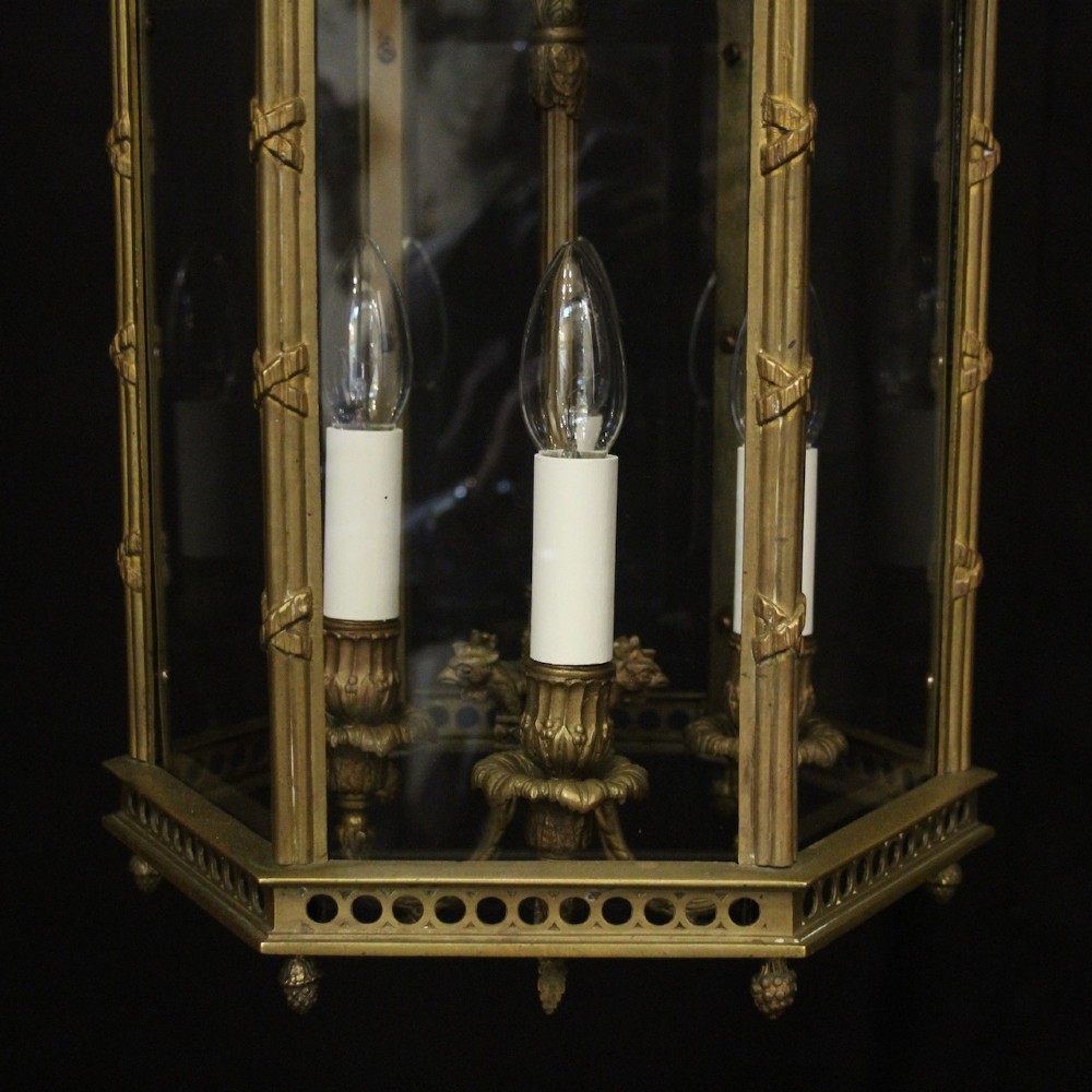 An English nineteenth-century gilded bronze four-light hall lantern with glazed glass panels and classical festoon ornamentation. View VII