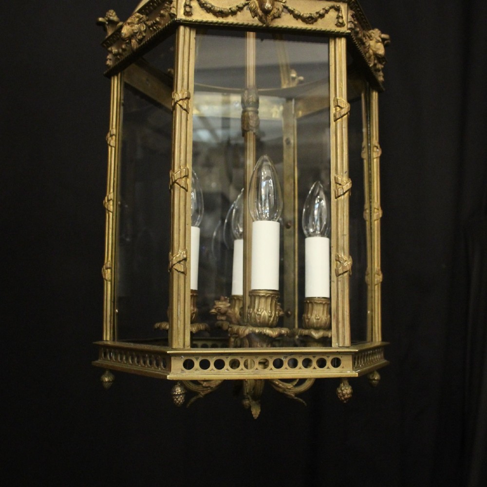 An English nineteenth-century gilded bronze four-light hall lantern with glazed glass panels and classical festoon ornamentation. View VIII