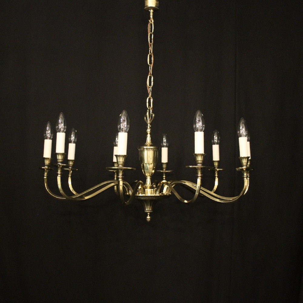 A repolished brass ten-light chandelier featuring sweeping curved arms, candle sleeves, and a central urn-shaped stem hanging from a chain. View II