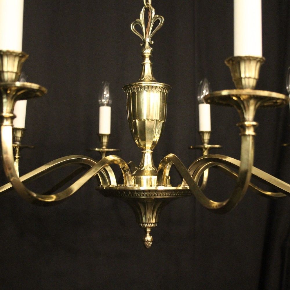 A repolished brass ten-light chandelier featuring sweeping curved arms, candle sleeves, and a central urn-shaped stem hanging from a chain. View III