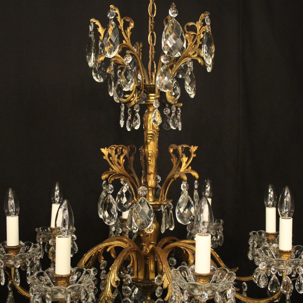 An eight-light French chandelier featuring a gilded metal frame adorned with cut crystal teardrop pendants and glass candle sleeves. View VIII