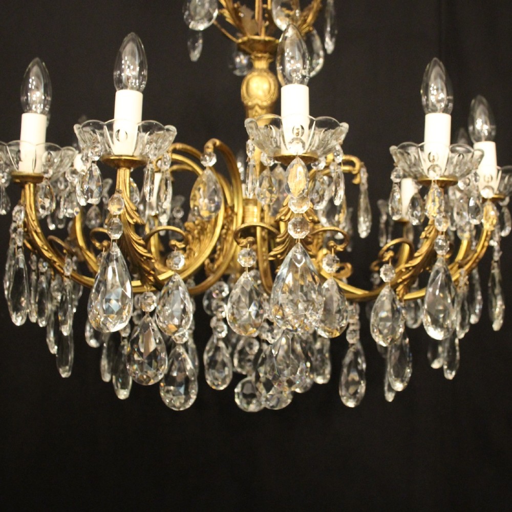 A French gilded brass twelve-light chandelier hung with faceted crystal droplets and glass bobeches. View III