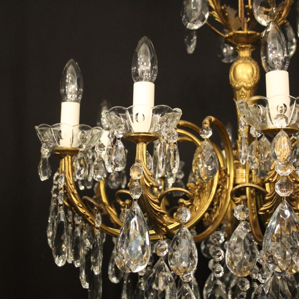 A French gilded brass twelve-light chandelier hung with faceted crystal droplets and glass bobeches. View V