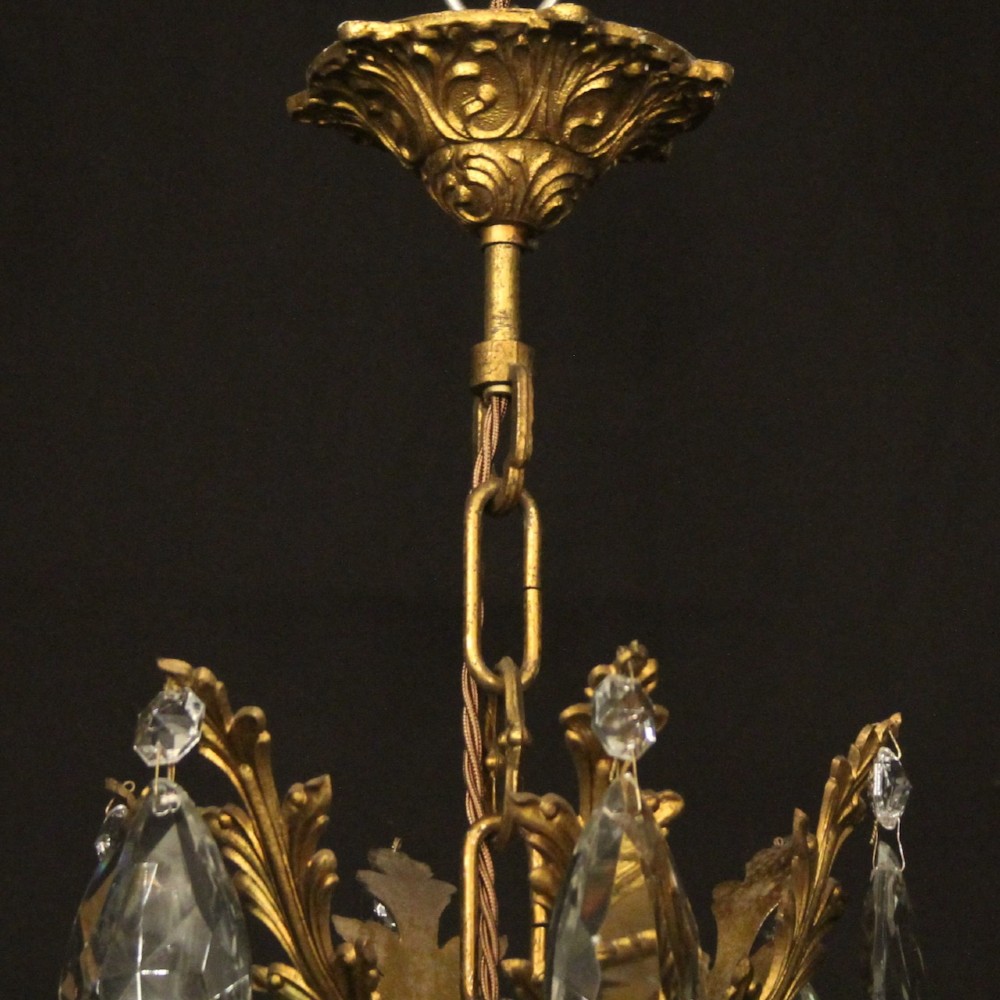 A French gilded brass twelve-light chandelier hung with faceted crystal droplets and glass bobeches. View X