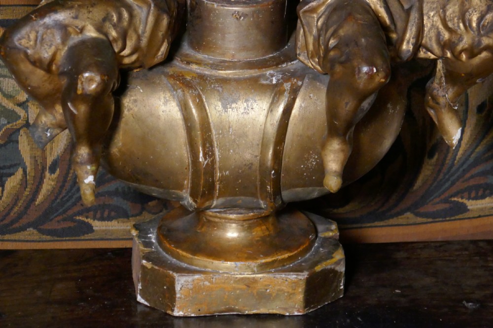 An 18th-century gilded carving featuring a central fluted column flanked by two seated mythological figures on an octagonal base. View V