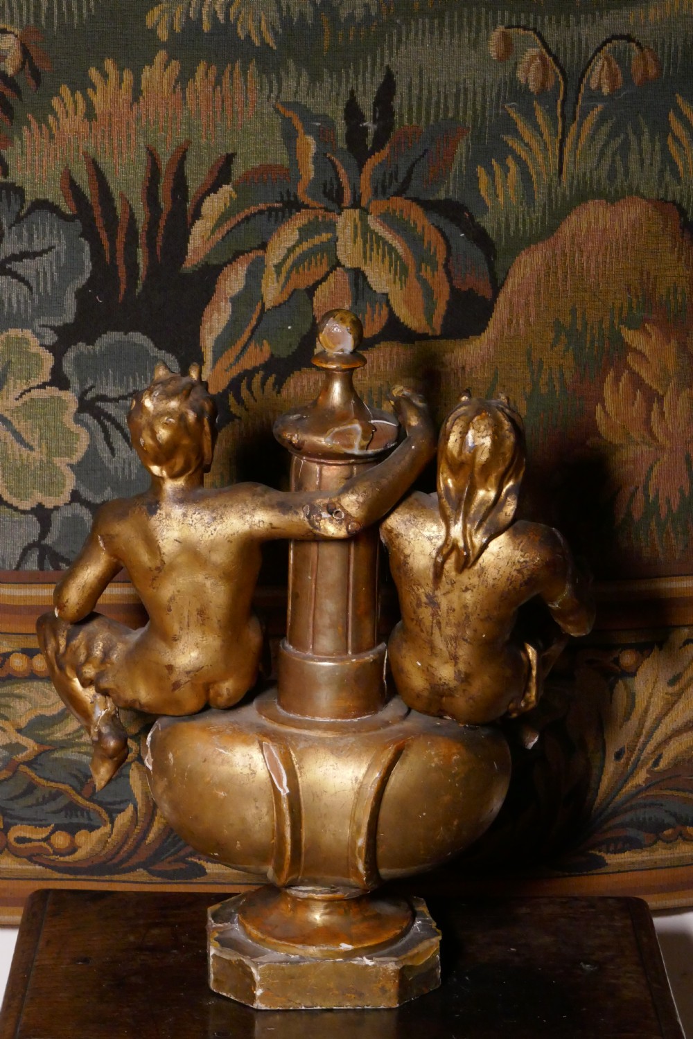 An 18th-century gilded carving featuring a central fluted column flanked by two seated mythological figures on an octagonal base. View VIII