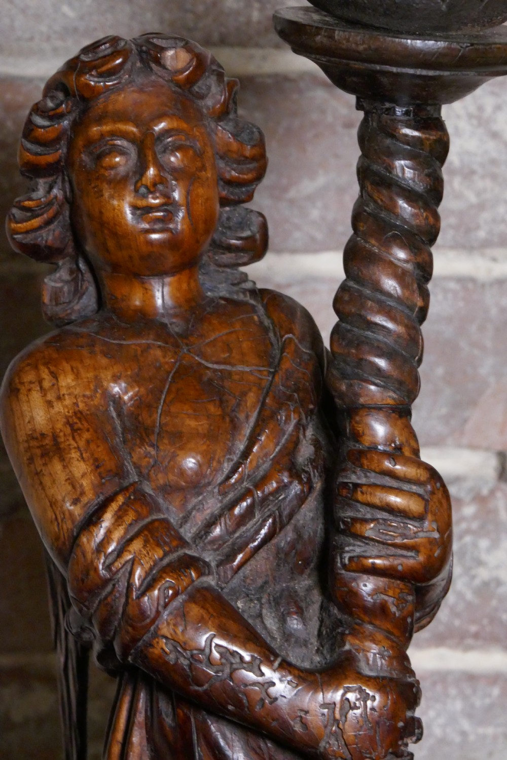 A pair of antique hand-carved wooden candlesticks depicting standing winged angels holding barley-twist pricket stands. View IX