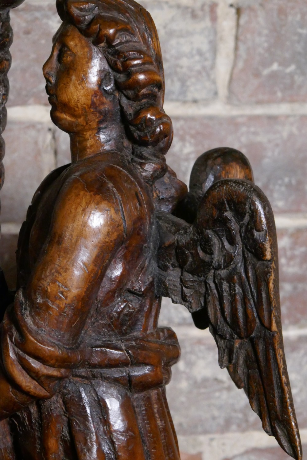 A pair of antique hand-carved wooden candlesticks depicting standing winged angels holding barley-twist pricket stands. View XVI