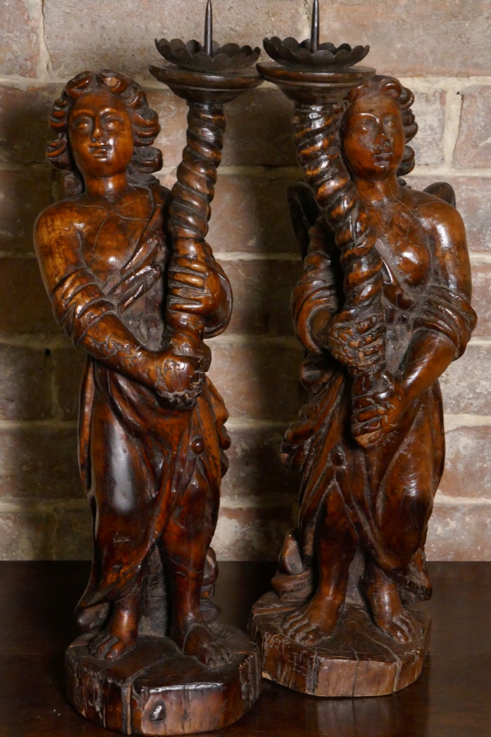 A pair of antique hand-carved wooden candlesticks depicting standing winged angels holding barley-twist pricket stands. View XVII