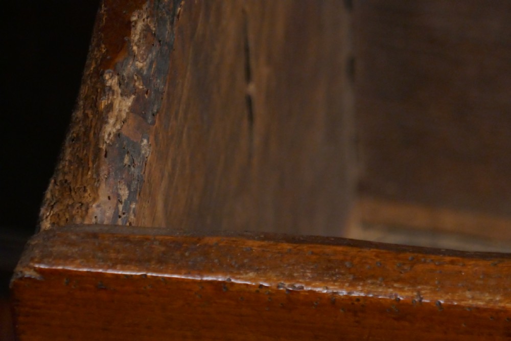 A dark oak 16th-century coffer featuring carved Gothic tracery panels and a central iron lock mechanism. View XV