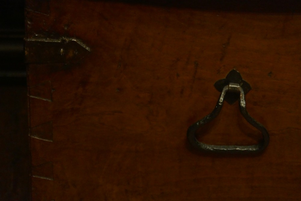 A dark oak 16th-century coffer featuring carved Gothic tracery panels and a central iron lock mechanism. View XVII