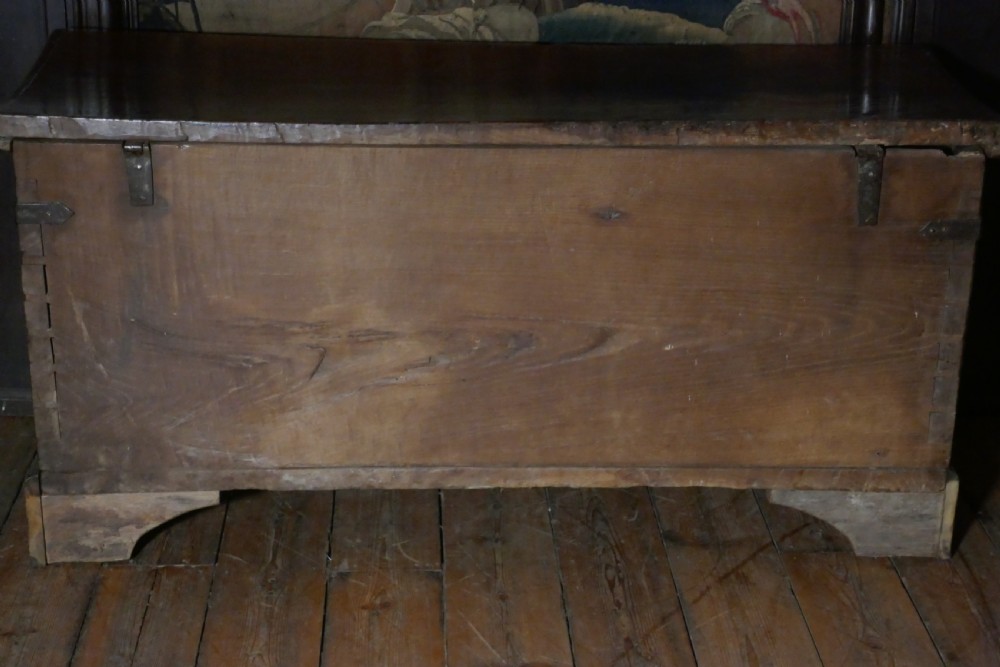 A dark oak 16th-century coffer featuring carved Gothic tracery panels and a central iron lock mechanism. View XIX