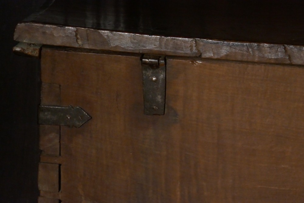 A dark oak 16th-century coffer featuring carved Gothic tracery panels and a central iron lock mechanism. View XX