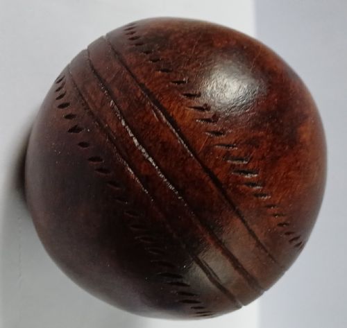 WOODEN SOLID WOOD CARVING OF A CRICKET BALL AS A DECK TOP ORNAMENT FOR THE MAN HAS EVERYTHING AND IS MAD ABOUT CRICKET PROBABLY MAHOGANY - ADDITIONAL PHOTO 1