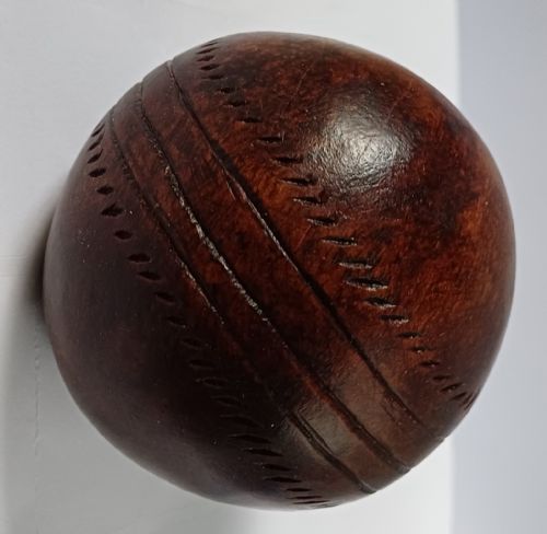 WOODEN SOLID WOOD CARVING OF A CRICKET BALL AS A DECK TOP ORNAMENT FOR THE MAN HAS EVERYTHING AND IS MAD ABOUT CRICKET PROBABLY MAHOGANY - ADDITIONAL PHOTO 2