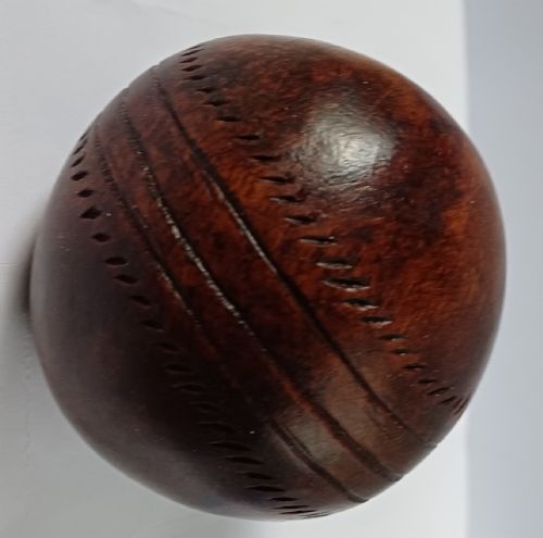 WOODEN SOLID WOOD CARVING OF A CRICKET BALL AS A DECK TOP ORNAMENT FOR THE MAN HAS EVERYTHING AND IS MAD ABOUT CRICKET PROBABLY MAHOGANY - ADDITIONAL PHOTO 3