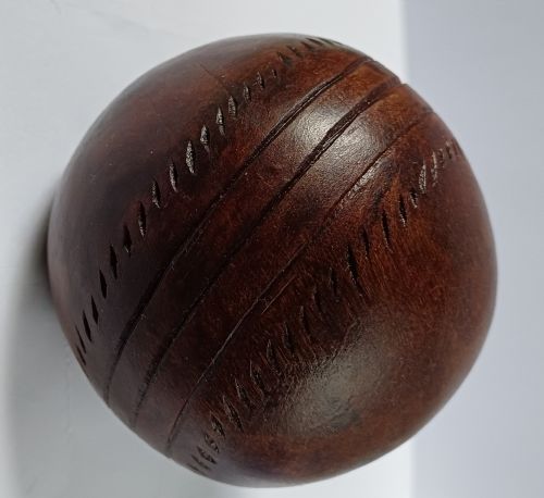 WOODEN SOLID WOOD CARVING OF A CRICKET BALL AS A DECK TOP ORNAMENT FOR THE MAN HAS EVERYTHING AND IS MAD ABOUT CRICKET PROBABLY MAHOGANY - ADDITIONAL PHOTO 11
