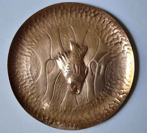 fig 1. A circular hand-hammered copper visiting card tray featuring a central repousse fish motif surrounded by chased water lines and a spot-hammered rim.