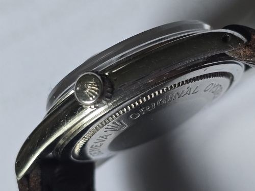 fig 5. A vintage Tudor Prince Oysterdate wristwatch with a stainless steel case, a black dial featuring baton hour markers, a date aperture at three oclock, and a dark brown leather strap.