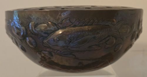 fig 1. A hand-hammered dark copper rose bowl featuring embossed fish motifs and a pierced top lid.