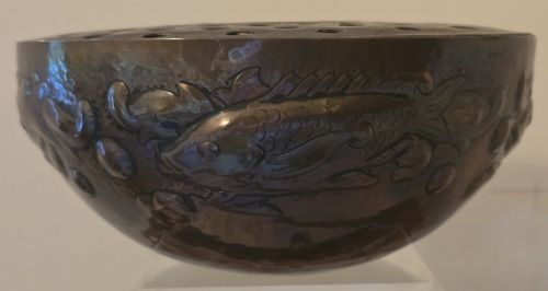 fig 2. A hand-hammered dark copper rose bowl featuring embossed fish motifs and a pierced top lid.