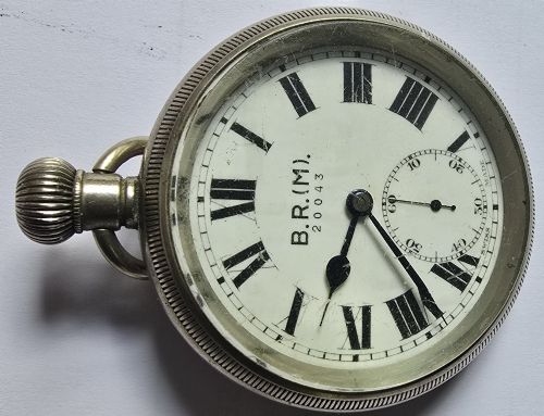 fig 3. A British Rail Midland Region open-face pocket watch featuring a white dial with Roman numerals, spade hands, and a subsidiary seconds subdial.