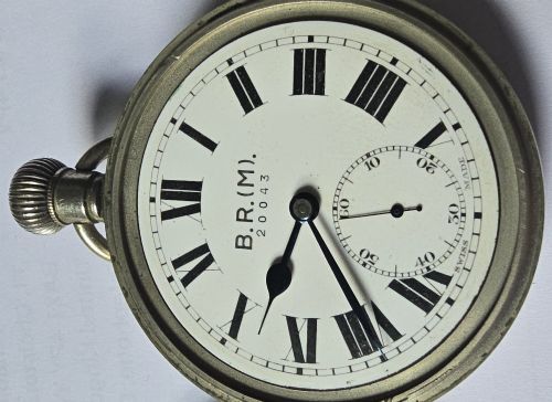 fig 5. A British Rail Midland Region open-face pocket watch featuring a white dial with Roman numerals, spade hands, and a subsidiary seconds subdial.