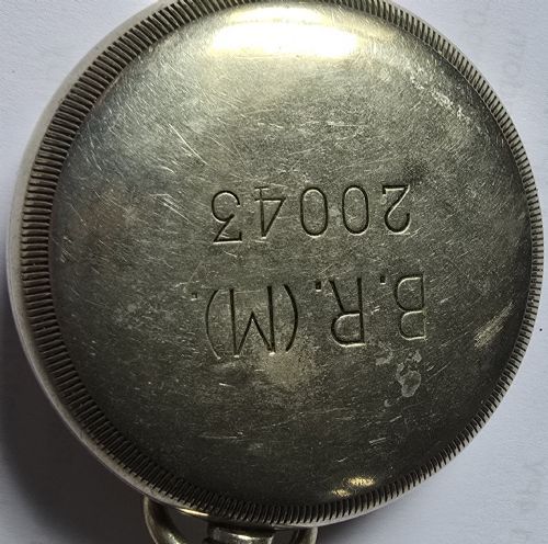 fig 7. A British Rail Midland Region open-face pocket watch featuring a white dial with Roman numerals, spade hands, and a subsidiary seconds subdial.