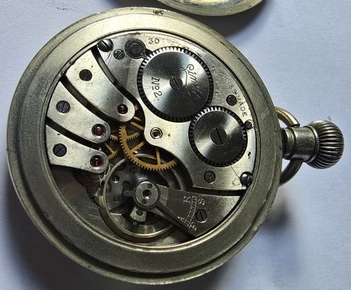fig 8. A British Rail Midland Region open-face pocket watch featuring a white dial with Roman numerals, spade hands, and a subsidiary seconds subdial.