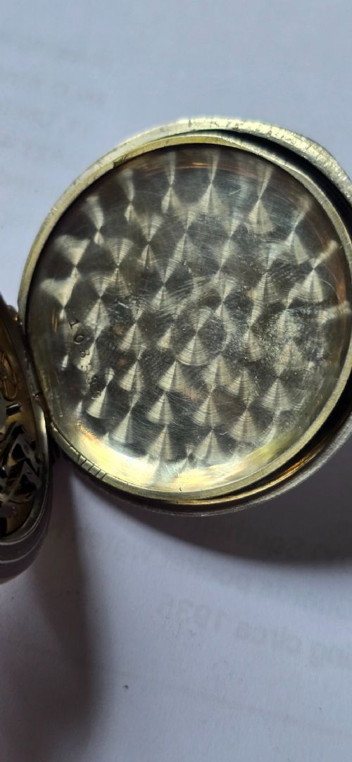 An open-face military pocket watch chronograph featuring a white enamel dial with black Arabic numerals, dual sub-dials, and French military markings enclosed in a round silver case. View XI