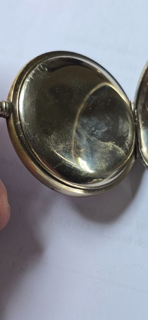 An open-face military pocket watch chronograph featuring a white enamel dial with black Arabic numerals, dual sub-dials, and French military markings enclosed in a round silver case. View XII