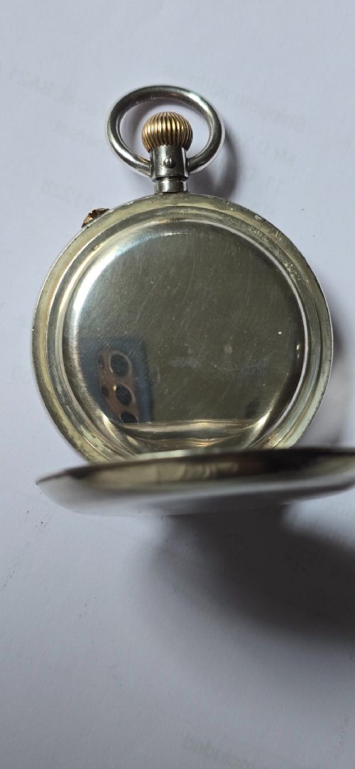 An open-face silver pocket watch featuring a white enamel dial with black Roman numerals, split-seconds hands, a subsidiary seconds dial, and a brass onion crown at the top. View XI