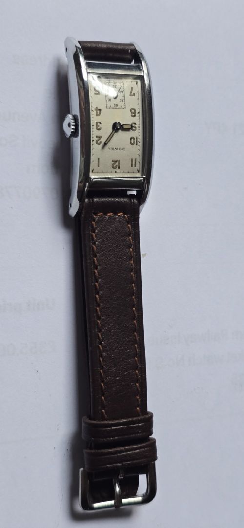 fig 1. A 1940s rectangular gents mechanical tank watch with a silver-tone case, cream dial featuring printed Arabic numerals and a sub-seconds dial, finished with a brown leather strap.