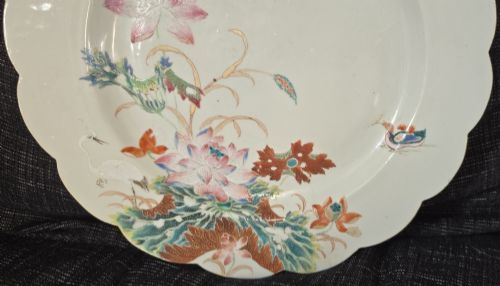 fig 2. An antique circular off-white porcelain dish with a scalloped rim, hand-painted with pink lotus blossoms, foliage, a crane, and a waterfowl.
