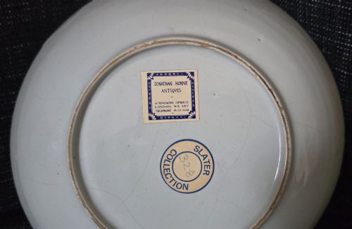 fig 2. An eighteenth-century circular English delftware saucer dish painted with a cobalt blue dragon motif on a white tin glaze.