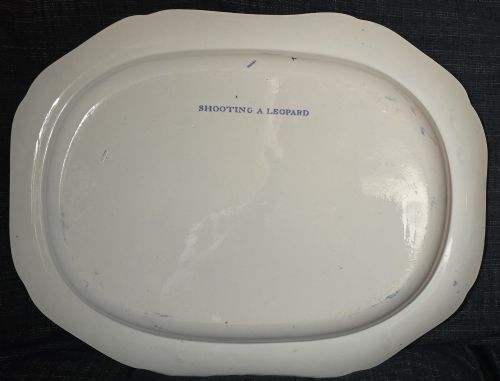 fig 1. An oval blue and white underglaze transfer-printed earthenware meat platter depicting a landscape with hunters on elephants and hounds pursuing a leopard.