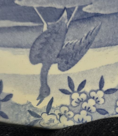 fig 3. An oval blue and white underglaze transfer-printed earthenware meat platter depicting a landscape with hunters on elephants and hounds pursuing a leopard.