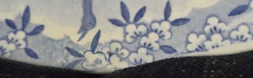 fig 4. An oval blue and white underglaze transfer-printed earthenware meat platter depicting a landscape with hunters on elephants and hounds pursuing a leopard.